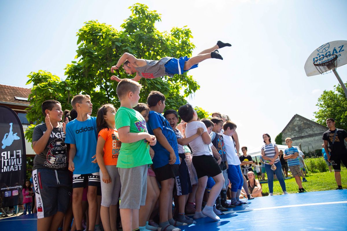 Airtrack acrobatics show jumping over people